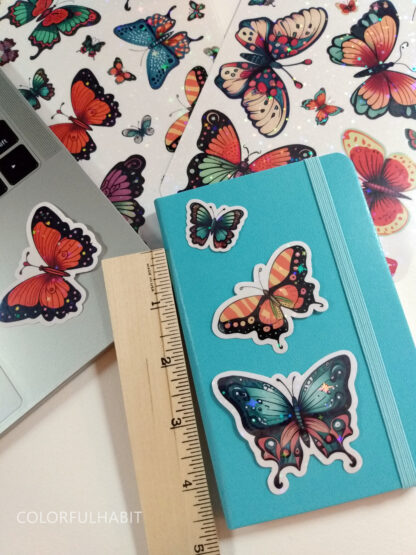 Butterflies Holographic Stickers on Notebook by ColorfulHabit