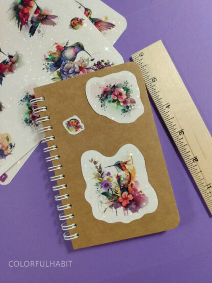 Hummingbird Holographic Stickers on Notebook by ColorfulHabit